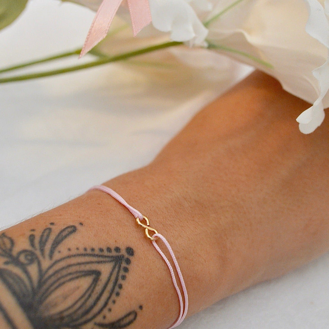 bracelet signe infini en or et cordon rose pale taille unique